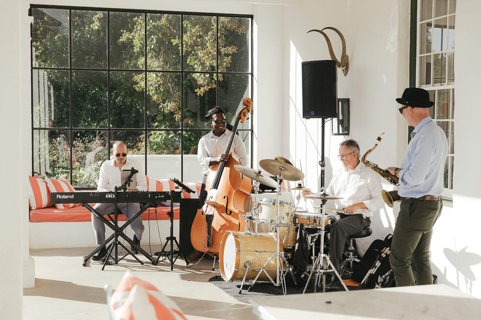 Four members of the Acoustic Jazz Quartet performing together at a ShoutMC event